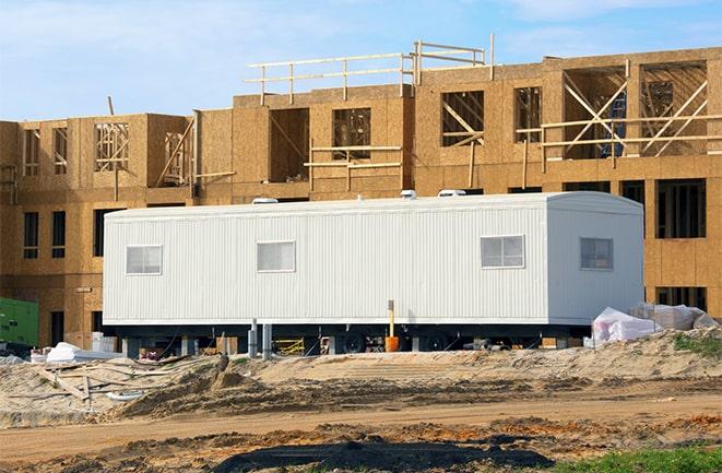 workers studying blueprints in a temporary rental office in Jacksonville Beach, FL